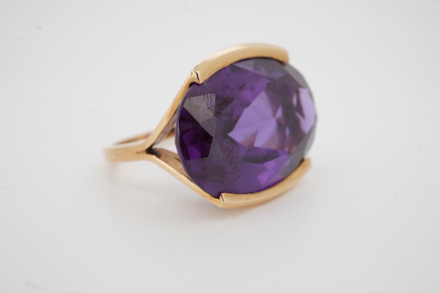 An 18k and single stone oval cut synthetic colour change corundum set dress ring, size P, gross weight 10.6 grams. Condition - good